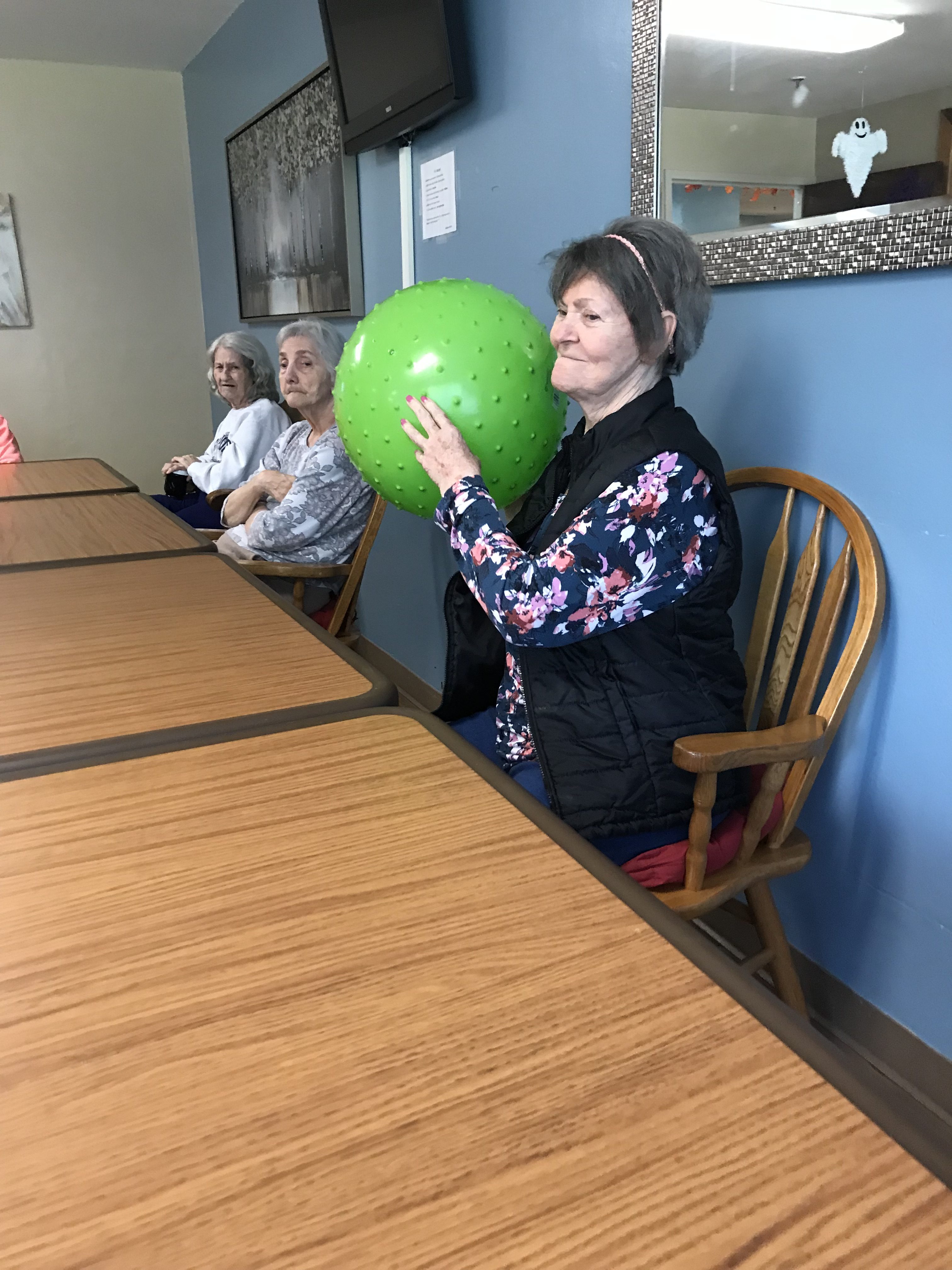 resident holding green ball